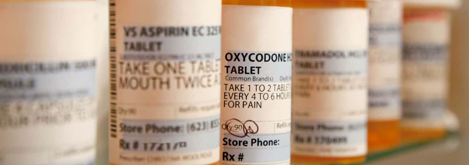 prescription pill bottles in medicine cabinet