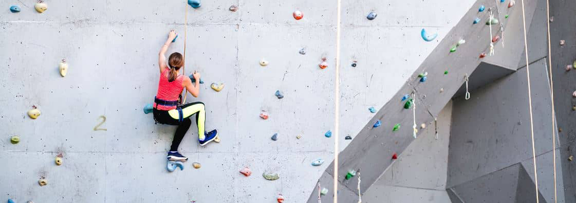 Woman climbing rock wall