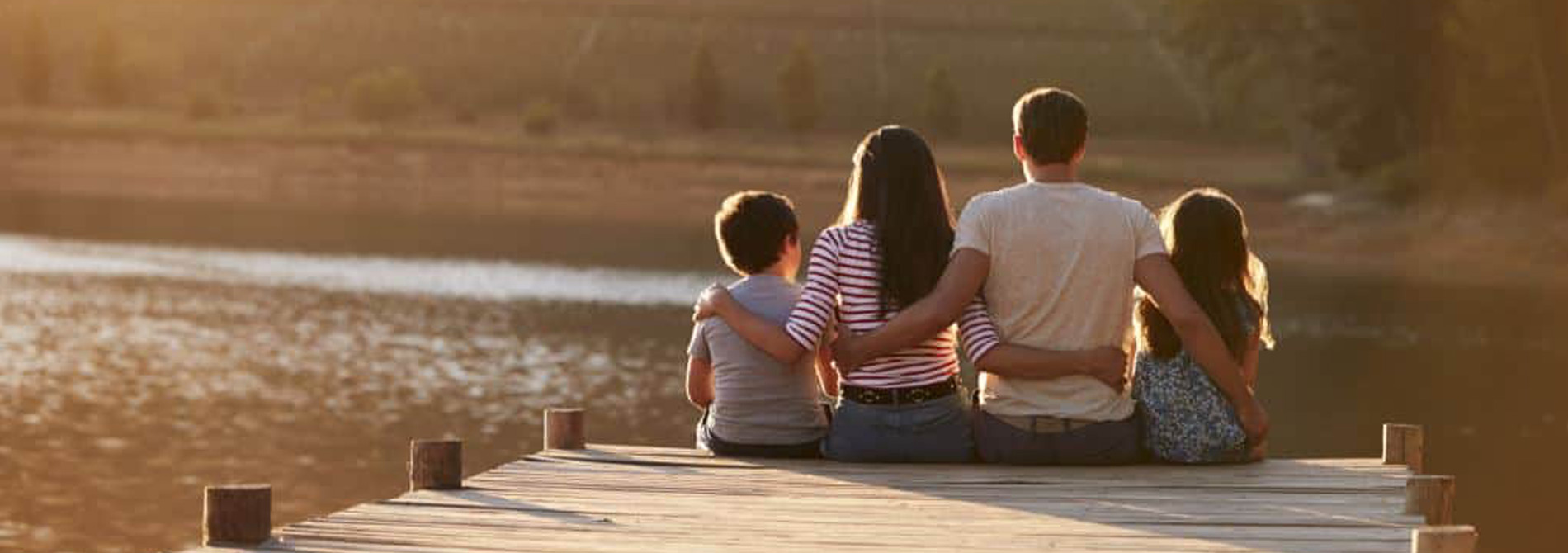 Family sitting on a dock