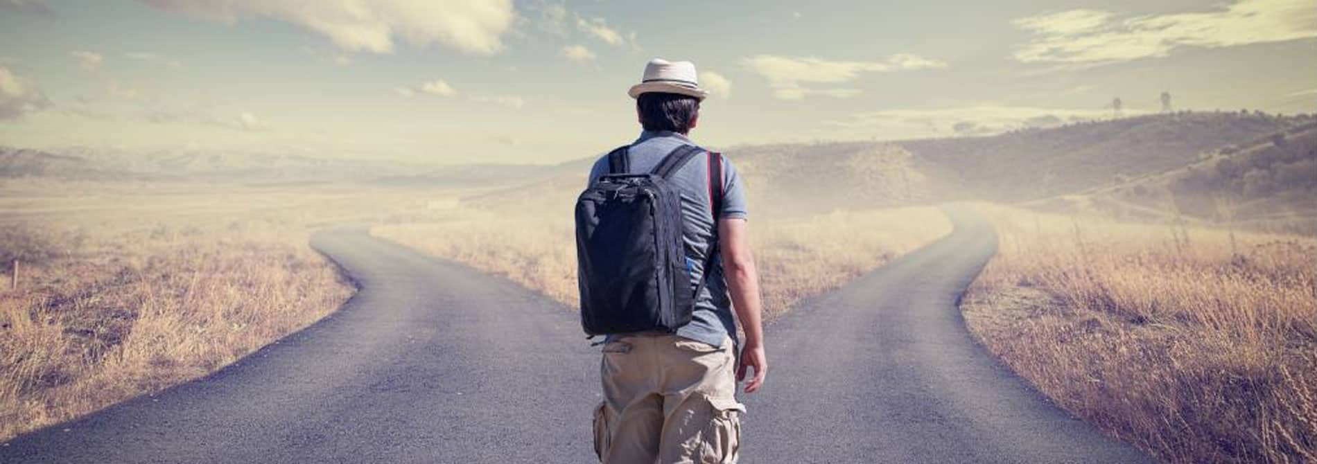 Man standing at a split in the road