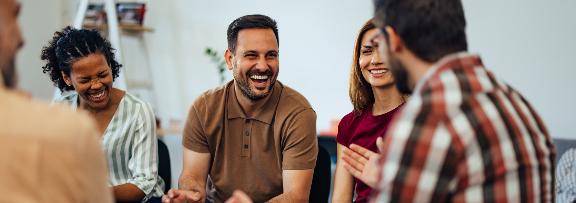 People smiling in group therapy session.