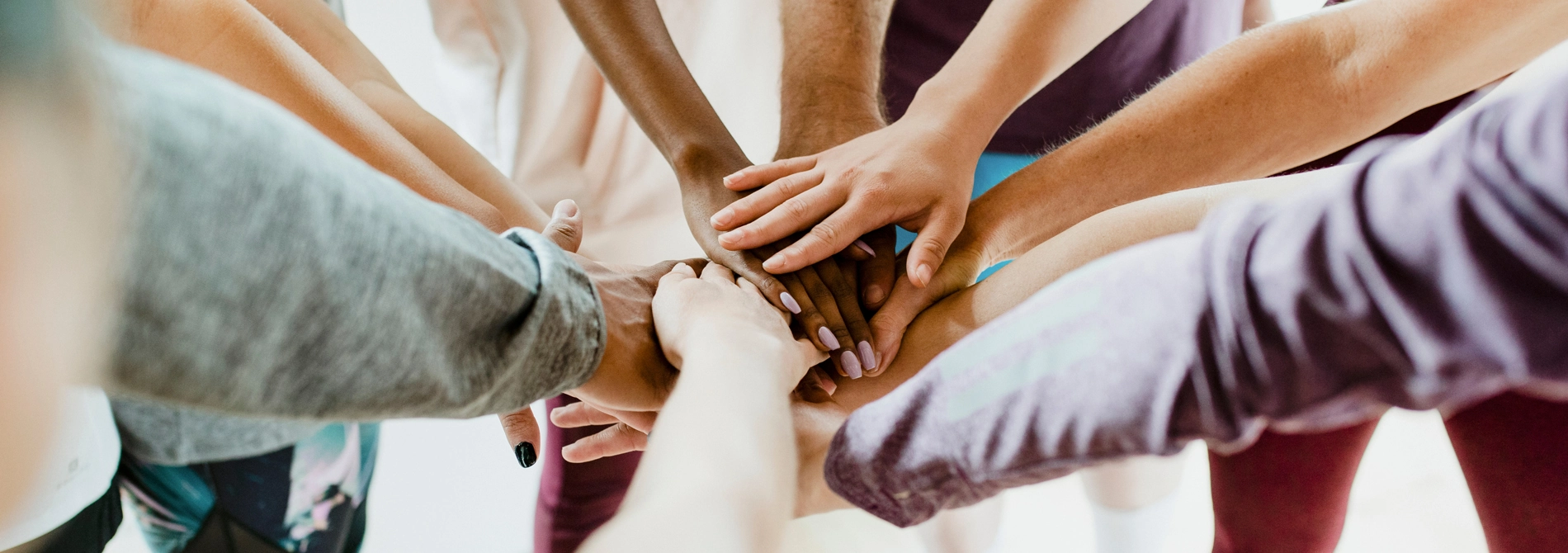 group of people piling hands together