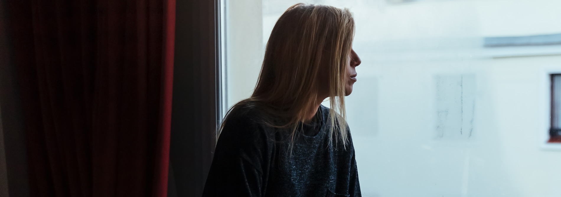 Woman looking through the window