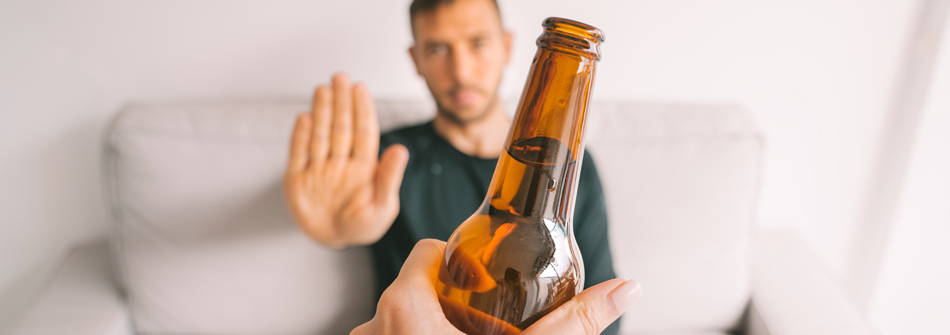 Young man refuses to drink beer.