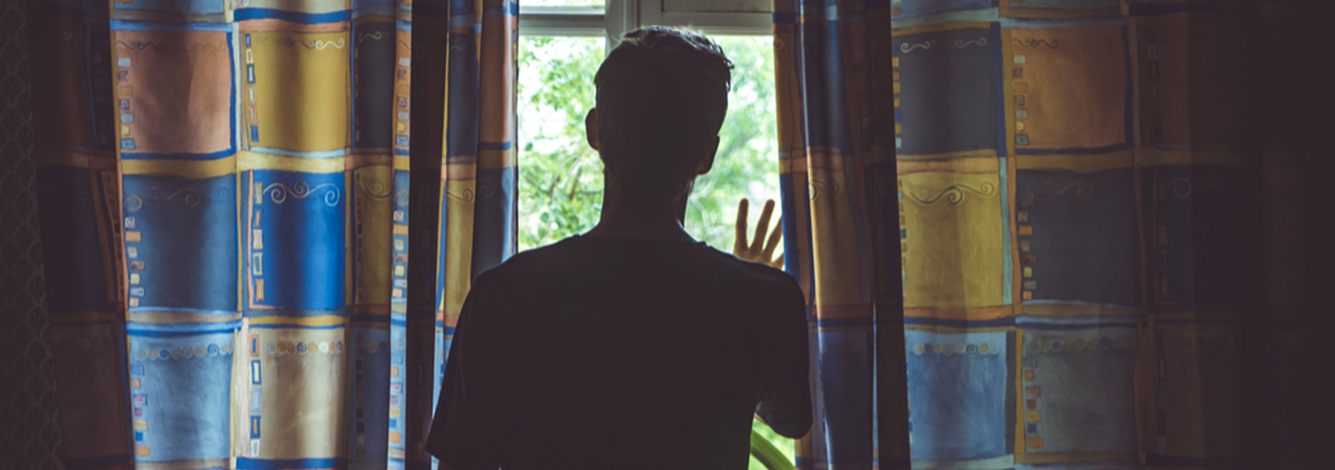 Man looking out window