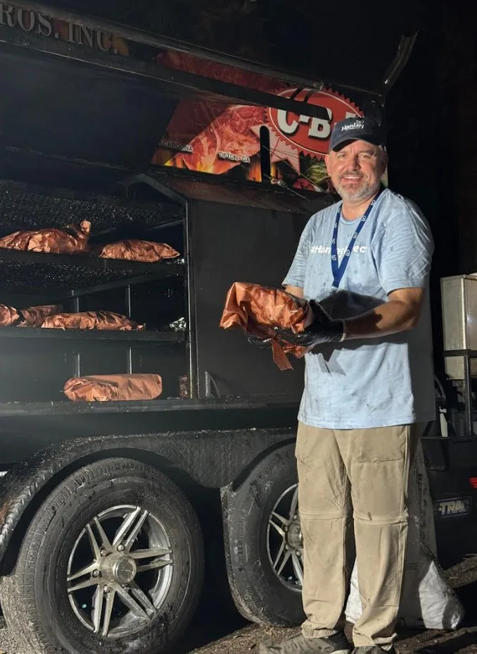 Dr. John Dyben cooking BBQ for the Alumni Reunion